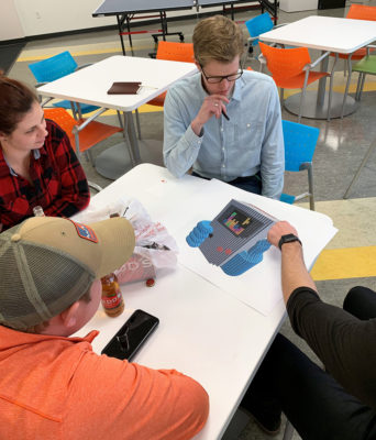 Team members gather after work to discuss strategy and structure plans